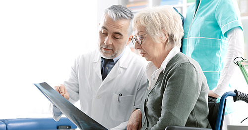 © StockPhotoPro / stock.adobe.com Arzt erklärt älterer Patientin Röntgenbild